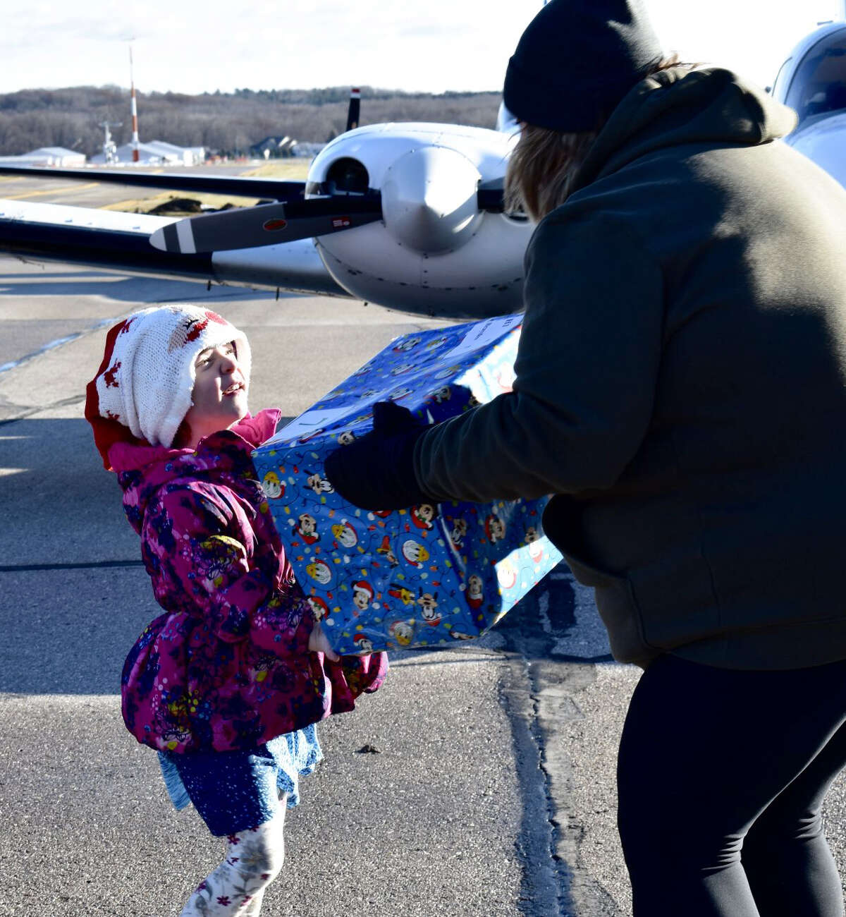 Volunteers spent Saturday morning unloading several gifts from planes at the Roben-Hood Airport in Big Rapids for this year's Operation Good Cheer. 