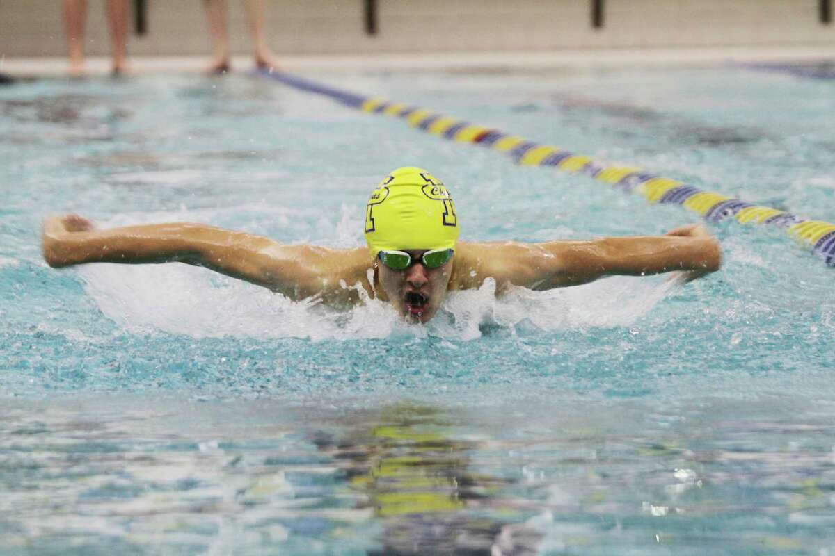 Manistee's Alec Lampen swims to victory in the 100-yard butterfly at the Paine Aquatic Center.