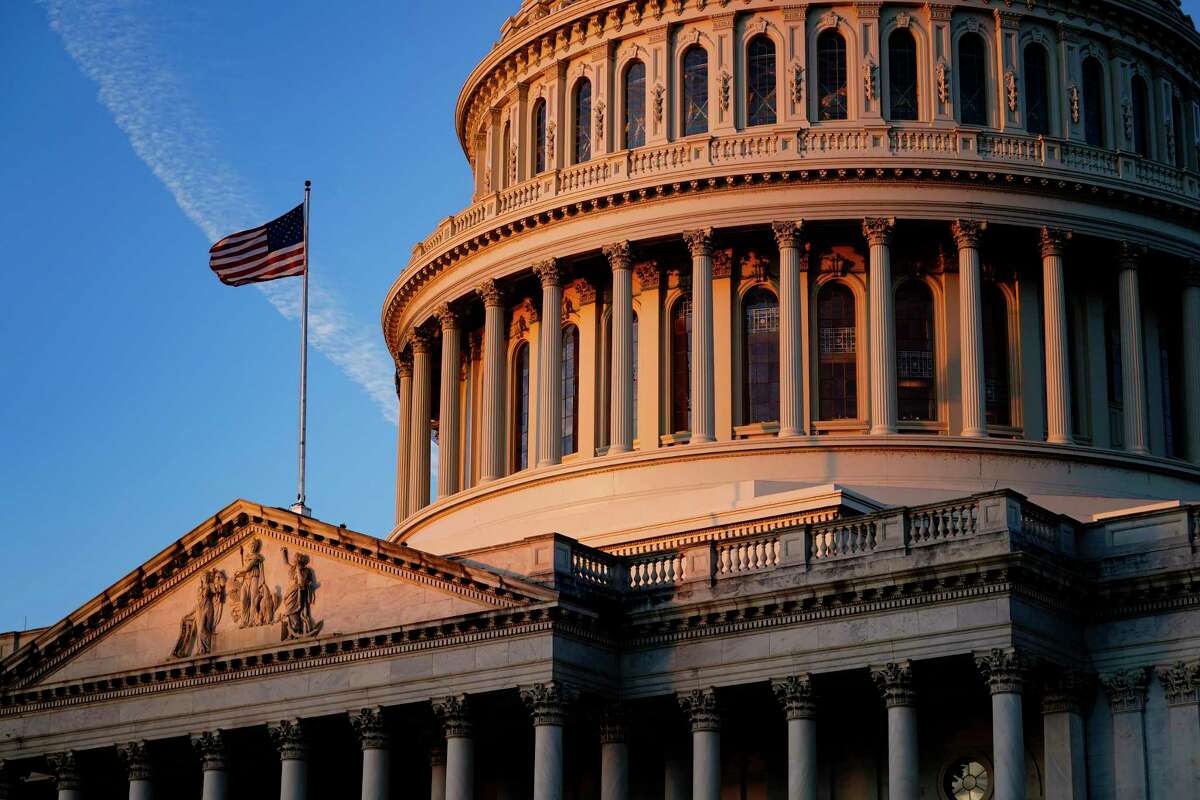 Light from the morning sun illuminates the Capitol in Washington, Friday, Dec. 3, 2021. (AP Photo/J. Scott Applewhite)