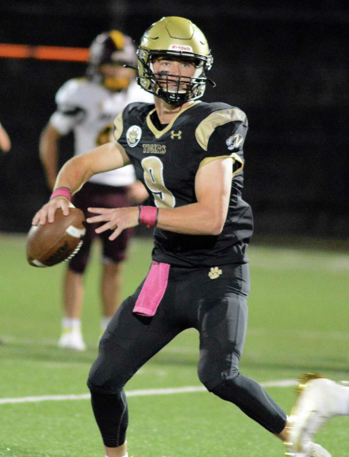 Hand QB Patch Flanagan looks for a receiver during a football game Friday night.
