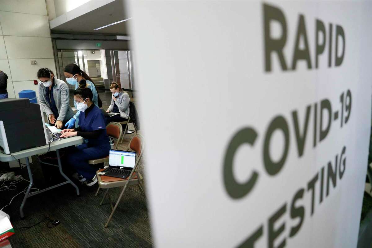 A rapid test site at San Francisco International Airport screens for COVID-19. New federal rules require all incoming international passengers to test for the virus within a day of boarding their flights to the U.S.