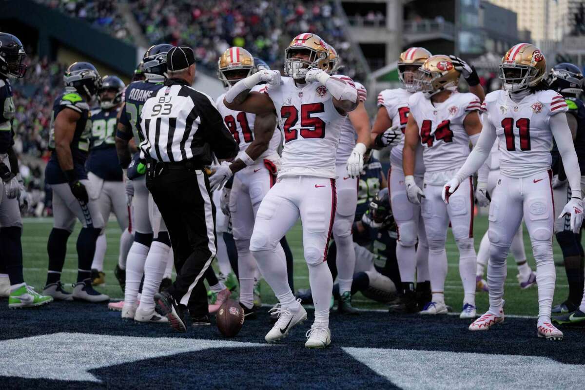 San Francisco 49ers running back Eli Mitchell celebrates a touchdown during an NFL football game against the Seattle Seahawks, Sunday, Dec. 5, 2021, in Seattle. The Seahawks won 30-23. (AP Photo/Ben VanHouten)