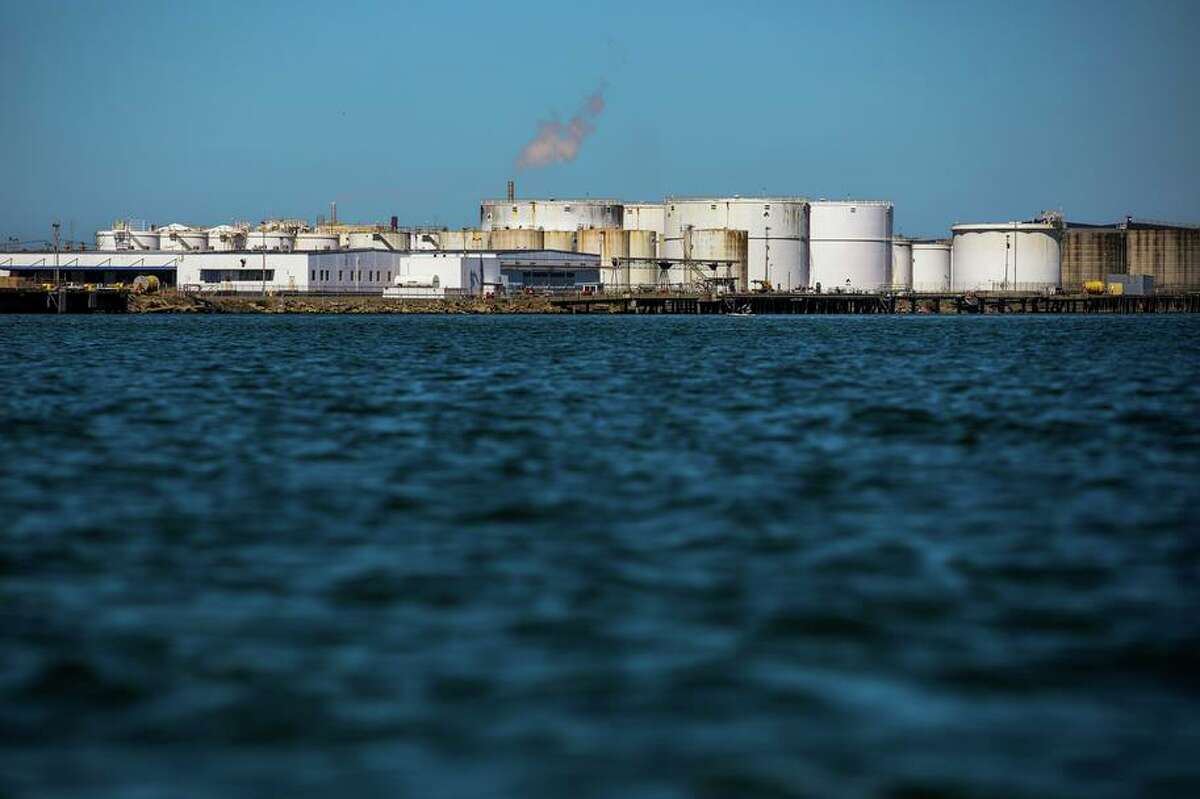 Richmond’s shoreline is dotted with 32 miles of heavy industry, including the Chevron oil refinery, shown here.