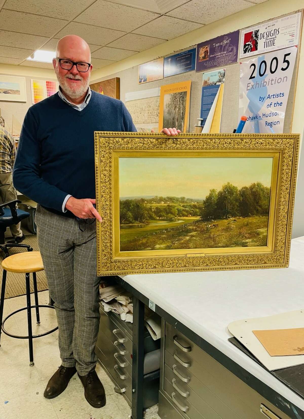 Albany Institute of History and Art Chief Curator Douglas McCombs shows a landscape painting by Julie Hart Beers. (Michelle Falkenstein)