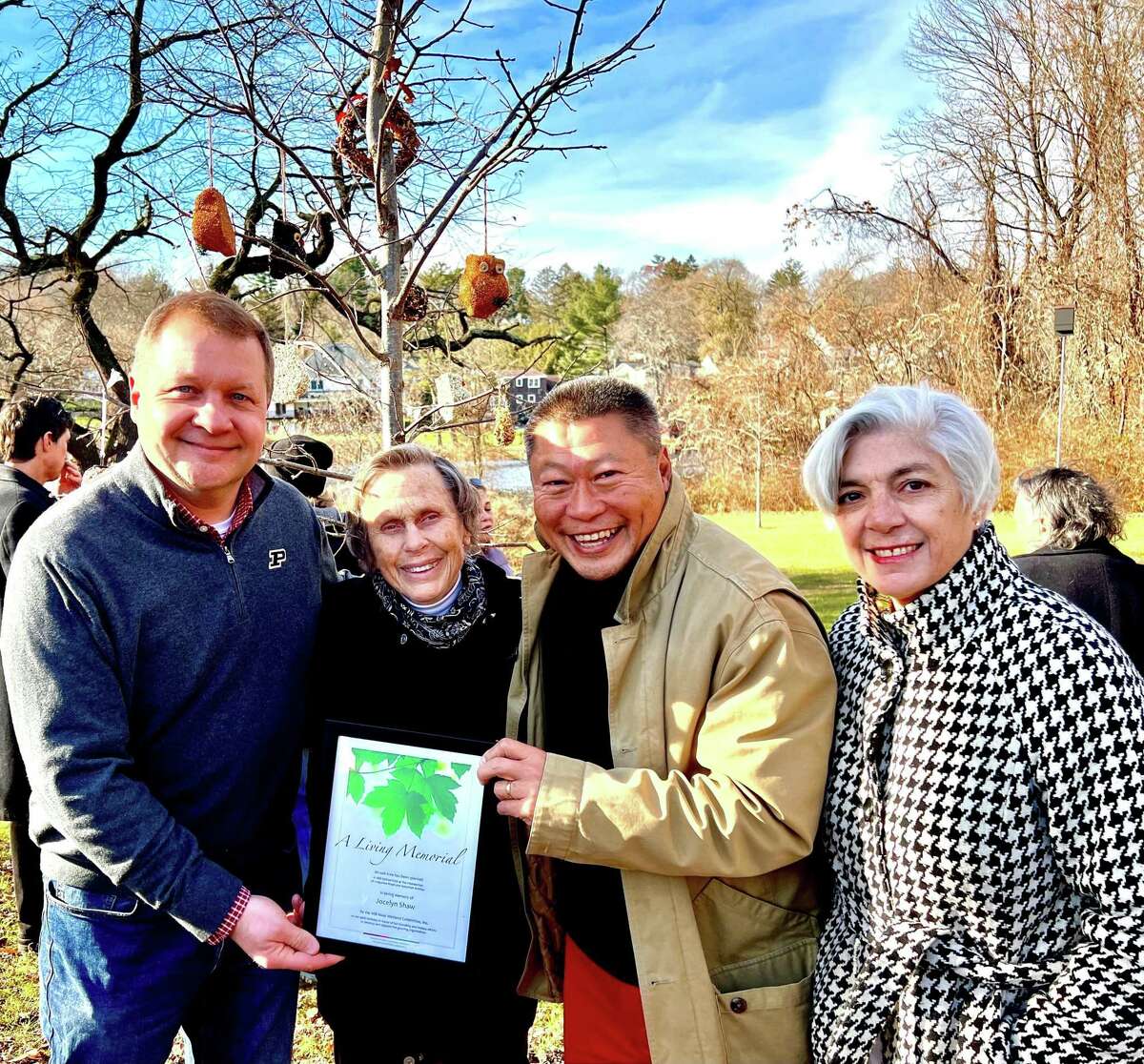 Jon Dilley, the president of the Mill River Wetland Committee; Joy Shaw; state Sen. Tony Hwang (R-28) and Mary Hogue, MRWC board member, at a dedication ceremony in which a tree was planted in honor of Shaw and her work creating the MRWC and it’s educational program Riverlab. The group stands in front of a chestnut oak planted as a living memorial.