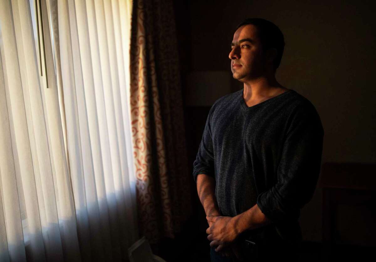 Sharif Mohammadi stands inside his hotel room in Columbus, Ohio. Sharif's older brother Ajmal Amani was shot and killed by San Francisco police on Nov. 19.
