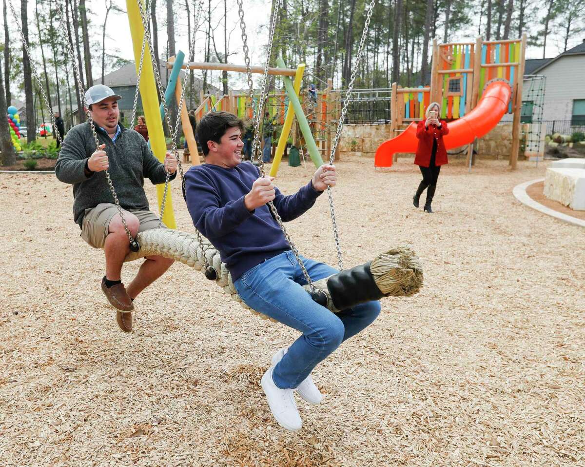 Willis golf players Mason Burris, left, and Colin Utecht play on a swing at the park dedicated to their former coach, Les Peacock at The Woodlands Hills, Tuesday, Dec. 7, 2021, in Willis. The Peacock’s family attended the dedication which honored the coach for his 13 years of service to the district and its students.