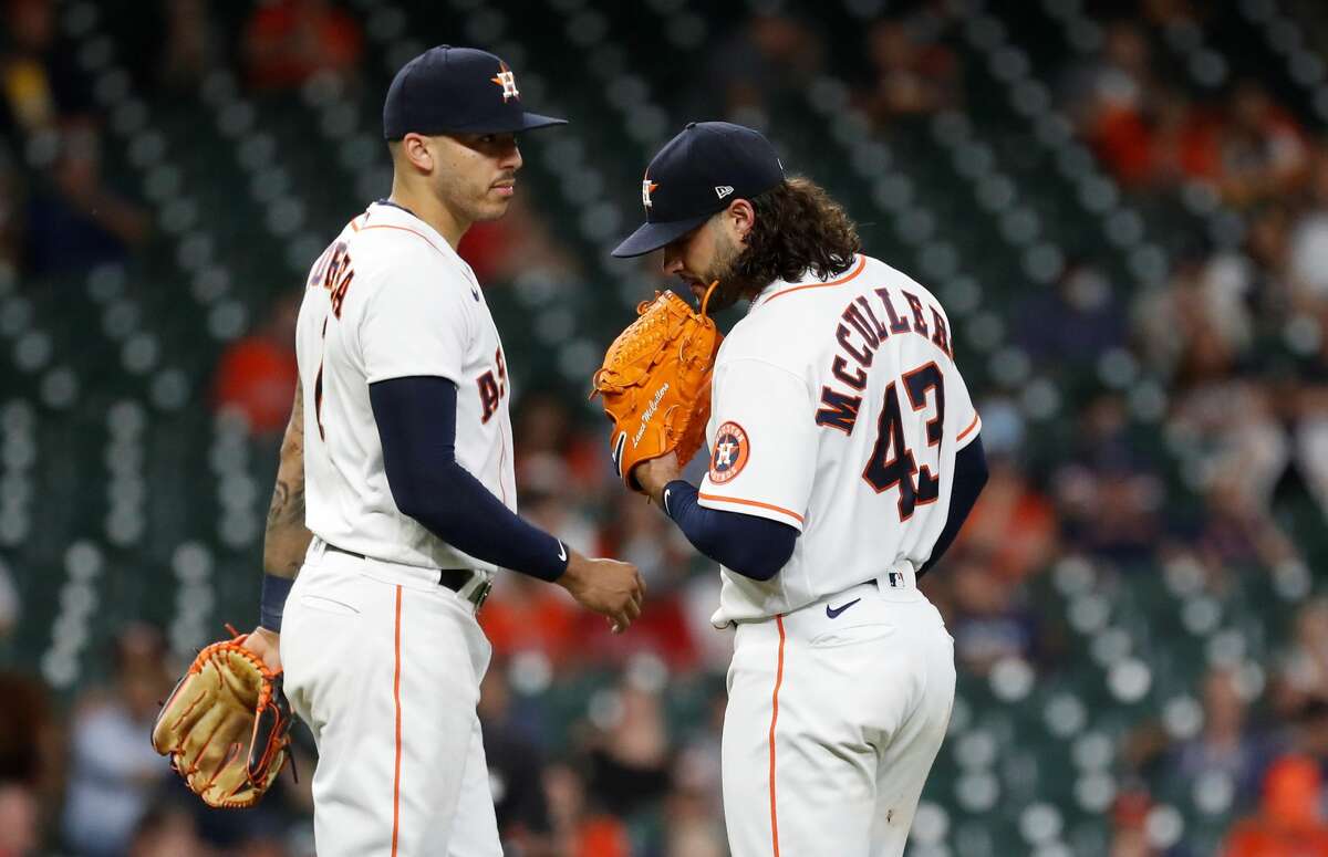 Houston Astros starting pitcher Lance McCullers Jr. (43) chats with shortstop Carlos Correa (1) after walking Los Angeles Angels Mike Trout during the seventh inning of an MLB baseball game at Minute Maid Park, Tuesday, May 11, 2021, in Houston.