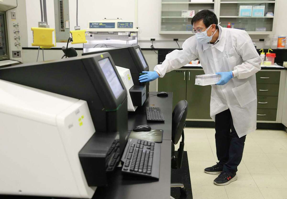 Dr. Weijing He, a molecular technologies specialist, works in a lab at UT Health San Antonio that performs Next Generation Sequencing on the COVID-19. San Antonio virus hunters search for the alpha, delta and possibly omicron variants from testing samples.