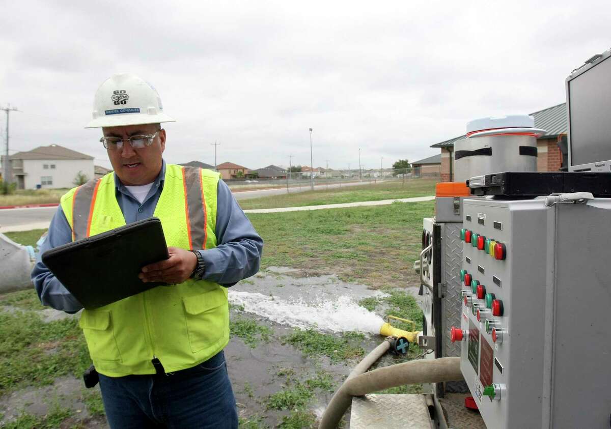 A San Antonio Water System meter technician tests the meter at Paschall Elementary School in December 2012. The meter was deemed sick, and a work order was placed to have the meter repaired. SAWS plans to replace its meters systemwide with new ones.