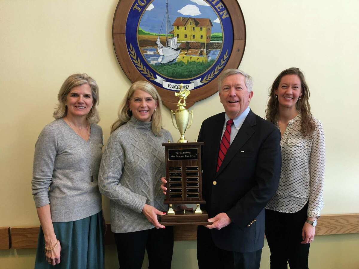 The transfer of the official Most Generous Town turkey trophy is shown. Janet King, left, executive director of The Community Fund of Darien and Darien First Selectman Jayme Stevenson along with New Canaan First Selectman Kevin Moynihan and Lauren Patterson, president & CEO of New Canaan Community Foundation.
