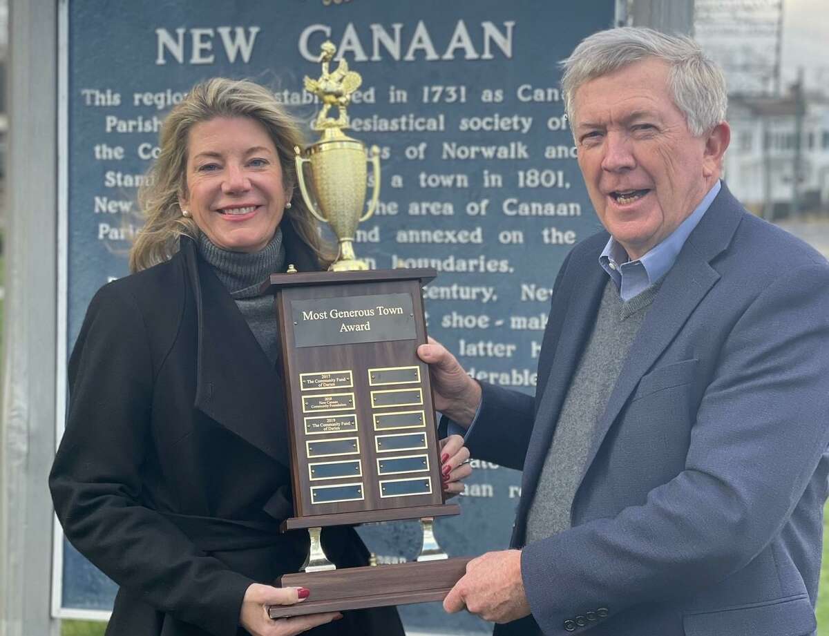 First Selectman of Darien Monica McNally and First Selectman Kevin Moynihan hold the most generous town trophy after New Canaan won the title in 2021. The two towns raised nearly $500,000 for charity.