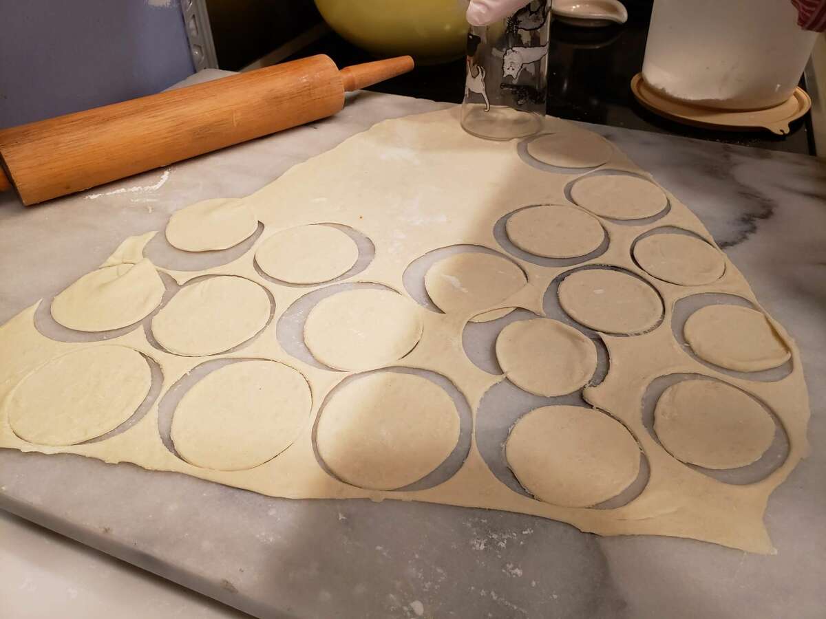 Pierogi dough is rolled out to a uniformly thin sheet – a tricky business – and cut out two inch circles. 