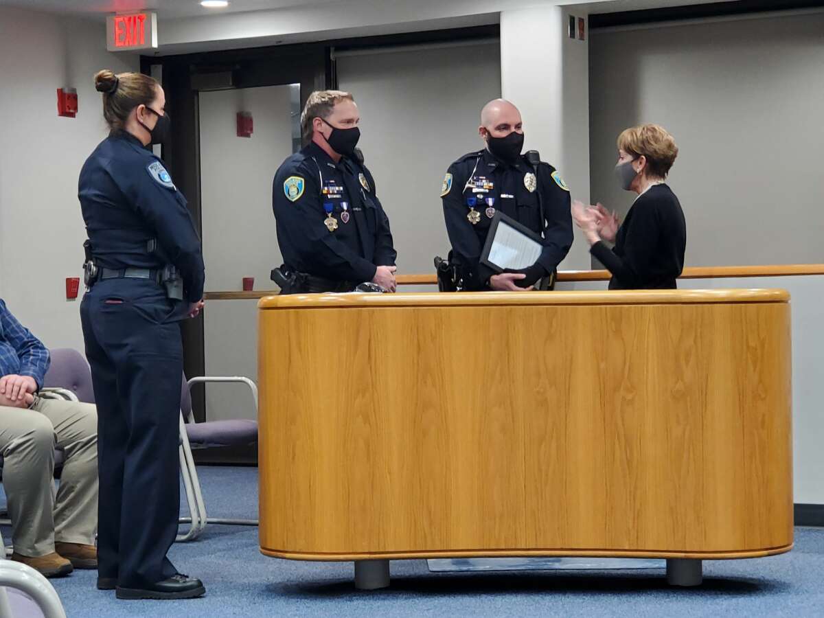Midland Mayor Maureen Donker (right) honors two Midland police officers on Dec. 6, 2021