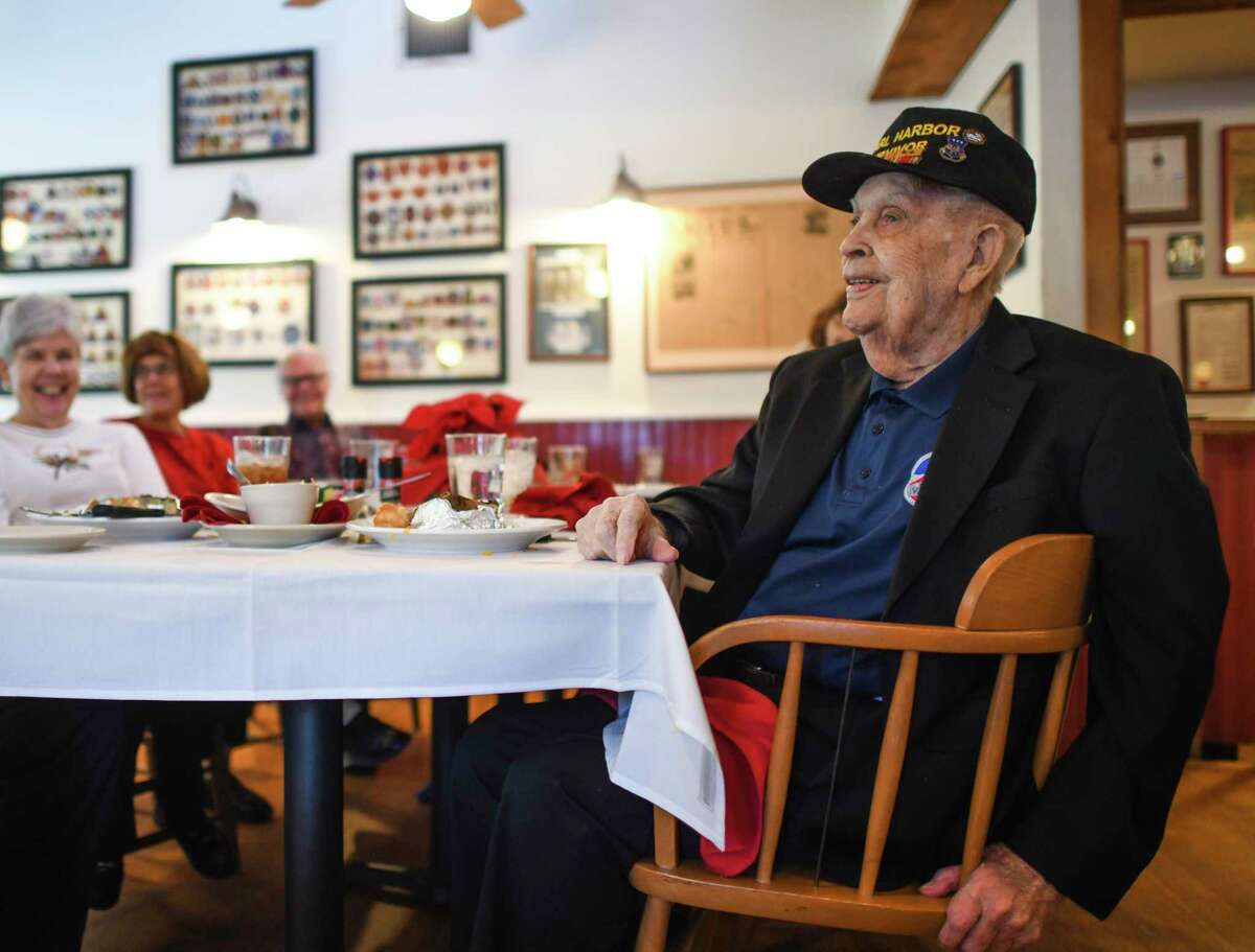 Pearl Harbor survivor Kenneth Platt smiles as he is applauded during Tuesday’s Pearl Harbor veterans’ gathering at The Barn Door restaurant on the 80th anniversary of the Japanese attack of Dec. 7, 1941. Platt was an infantryman at Schofield Barracks when the attack occurred.