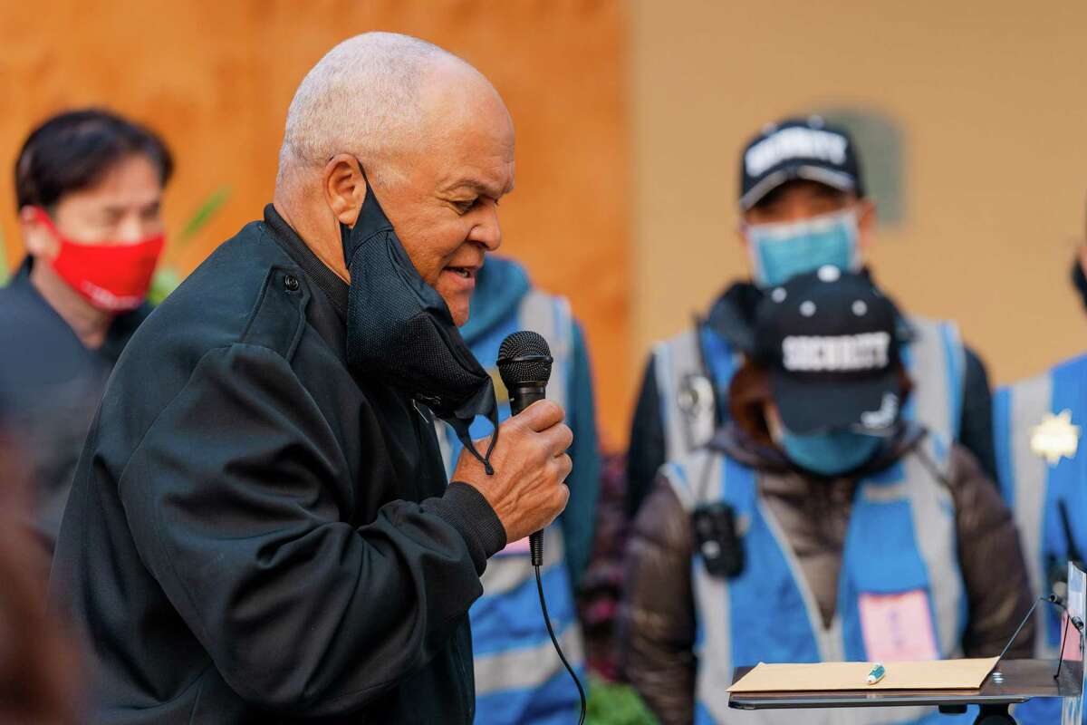 Bishop Bob Jackson from Acts Full Gospel Church of God leads a prayer during a press conference in Oakland, Calif. calling on the city to grow its police force.