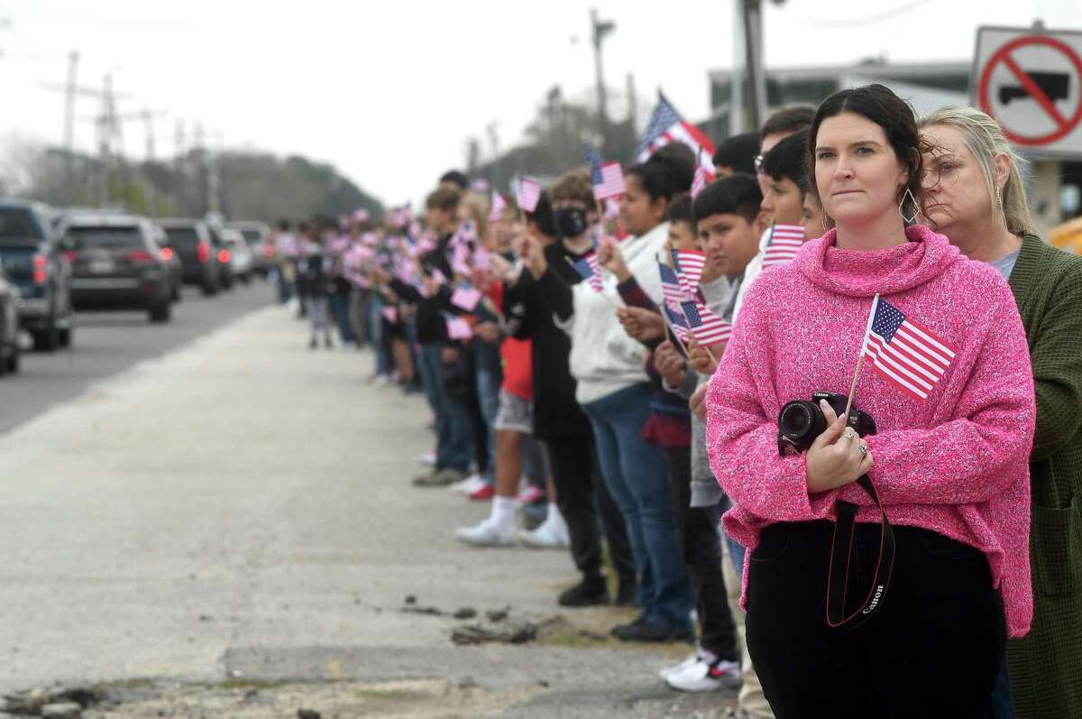 Students and staff lined the funeral procession route waving flags as it passed by East Chambers High School during the funeral service for Winnie native and Seaman 2nd Class Charles L. Saunders, who was killed 80 years ago during the attack on Pearl Harbor. Photo made Tuesday, December 7, 2021 Kim Brent/The Enterprise