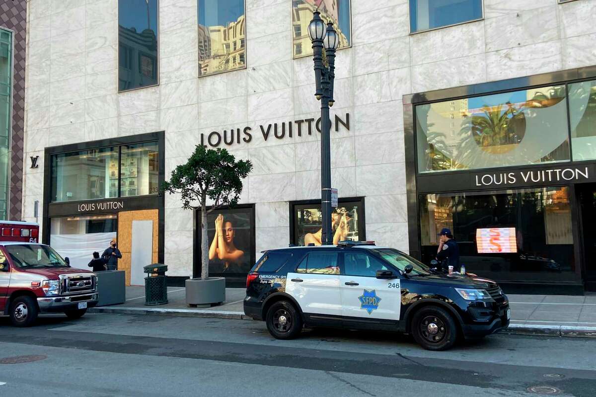 FILE - Police officers and emergency crews park outside the Louis Vuitton store in San Francisco's Union Square on Nov. 21, 2021, after looters ransacked businesses. Groups of thieves smashed glass cases and window displays, ransacking high-end stores throughout the Bay Area. (Danielle Echeverria/San Francisco Chronicle via AP, File)