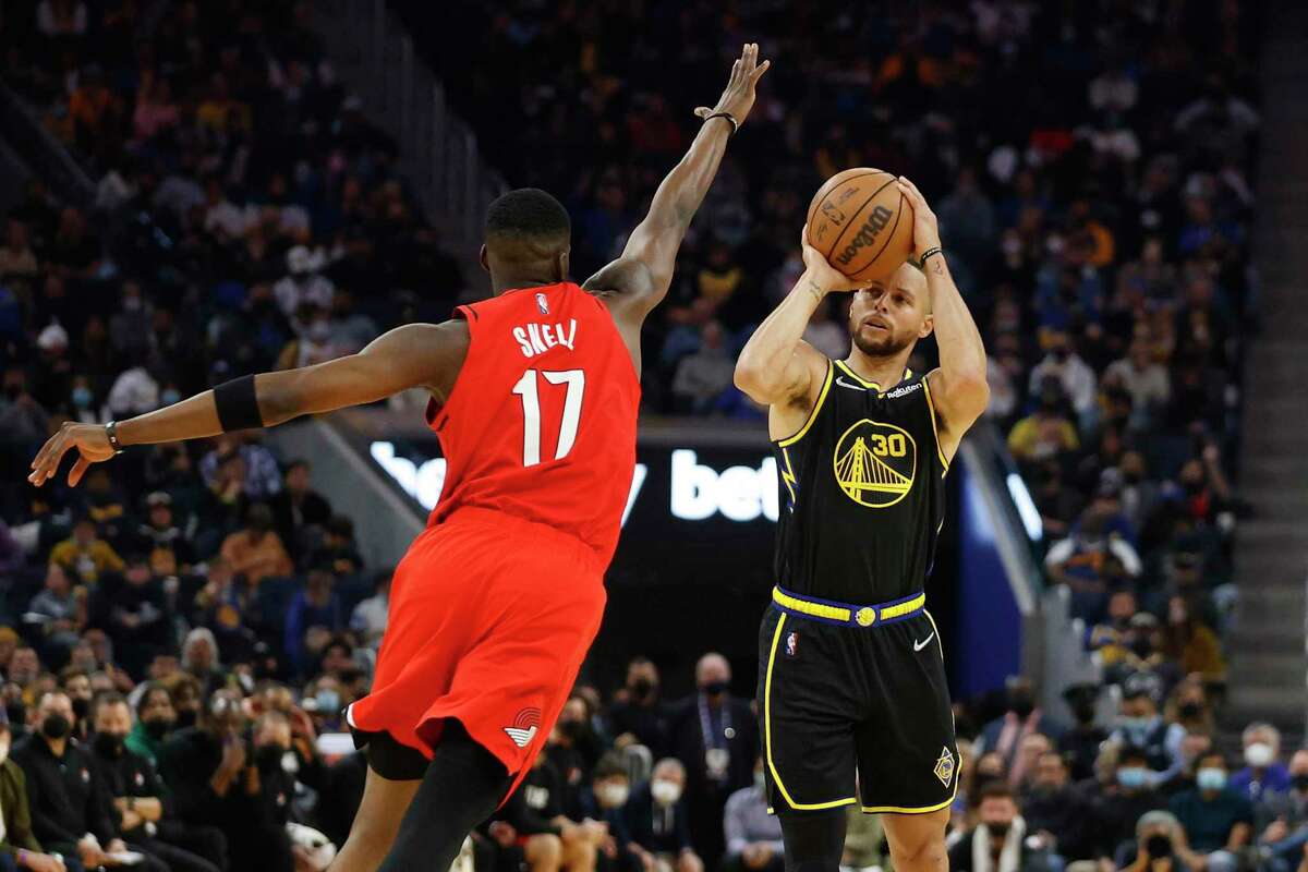 Warriors guard Stephen Curry shoots a 3-pointer as Portland Trail Blazers guard Tony Snell defends during the first quarter in San Francisco on Nov. 26, 2021.