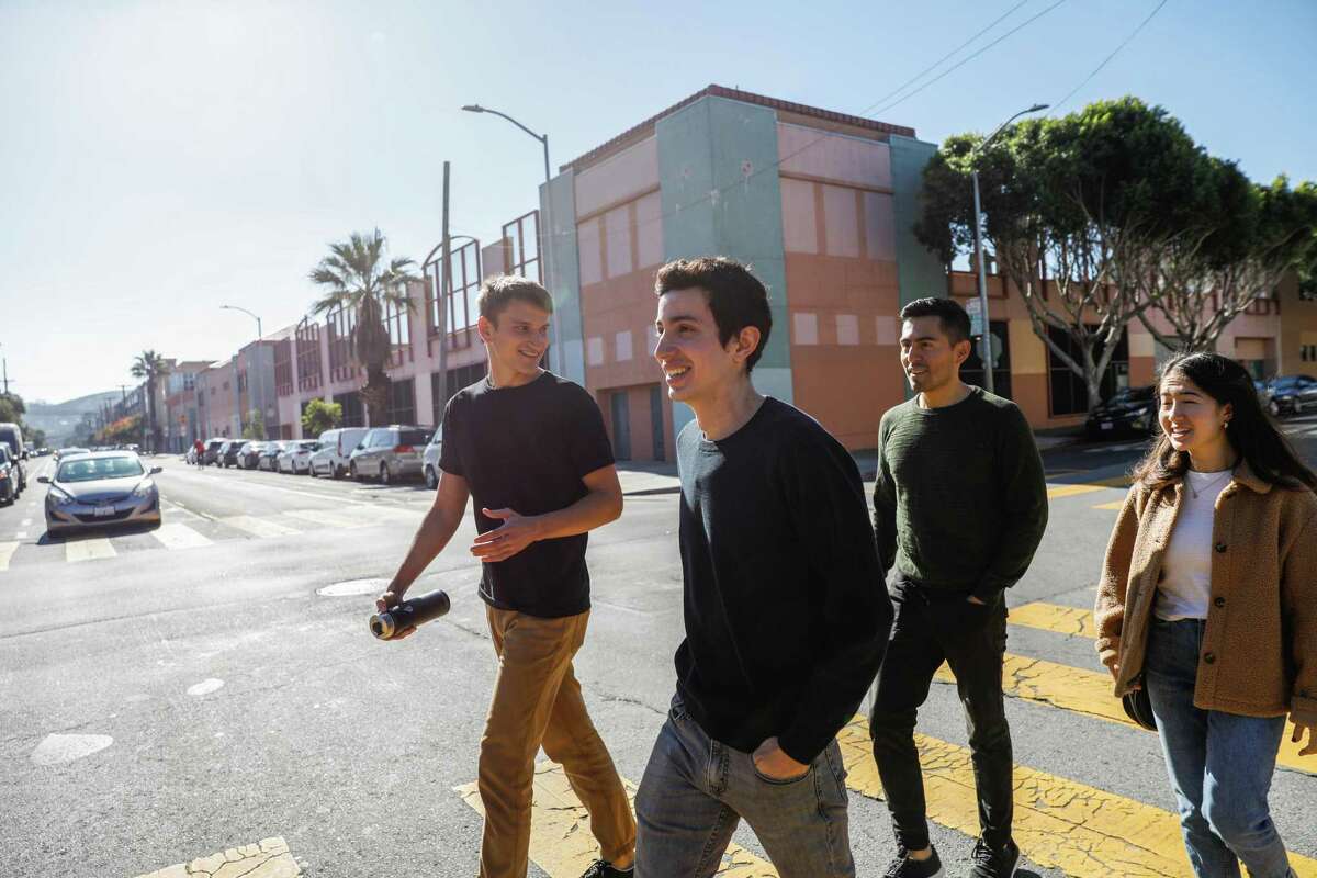 Juan Saldaña (second from left) walks to lunch with his roommates. He moved to San Francisco from Texas in January.