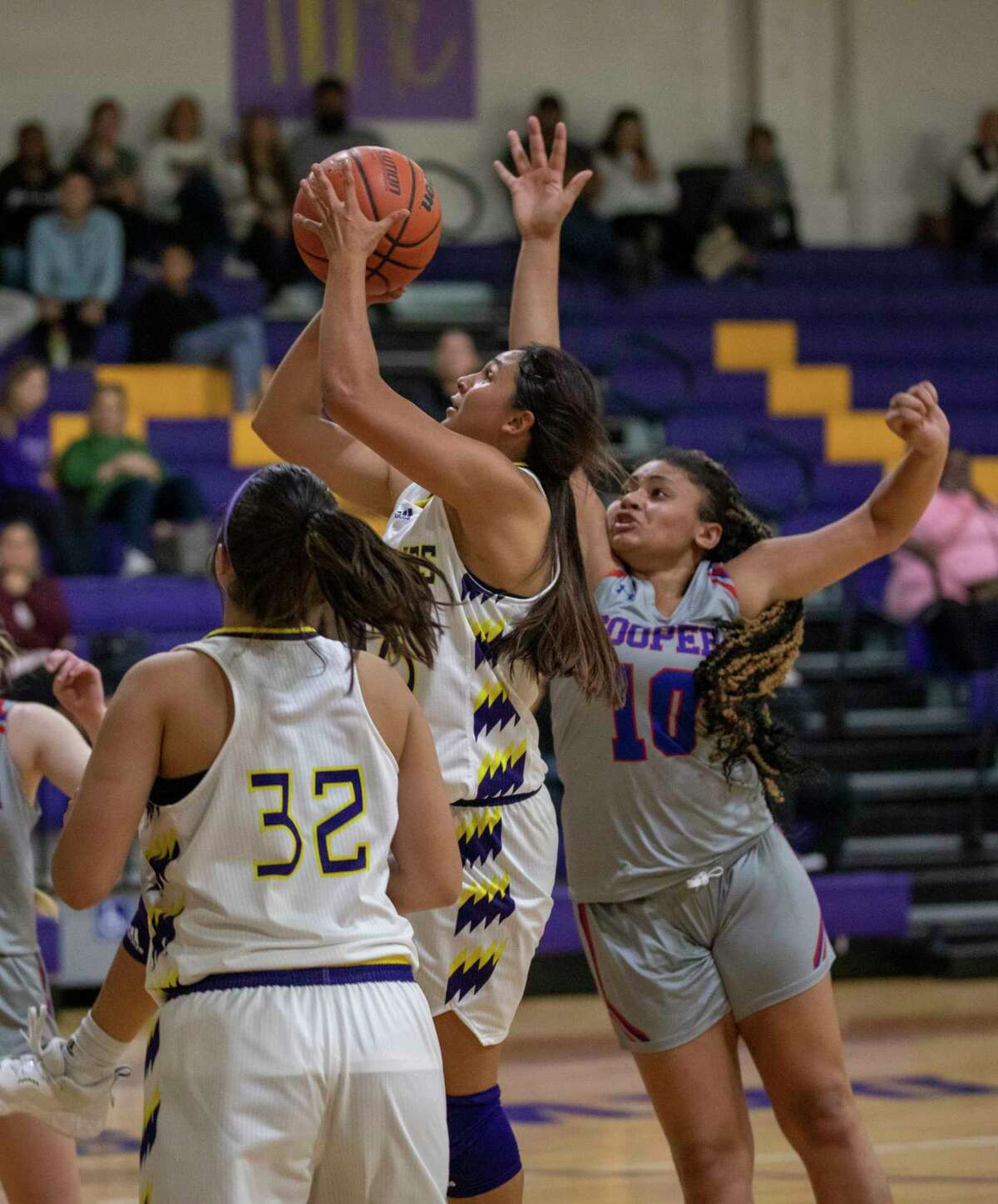 Midland High’s Noemi Arciga shoots the ball as Abilene Cooper’s Asjha Cherry attempts to block the shot Tuesday, Dec. 7, 2021 at Midland High School. Jacy Lewis/Reporter-Telegram