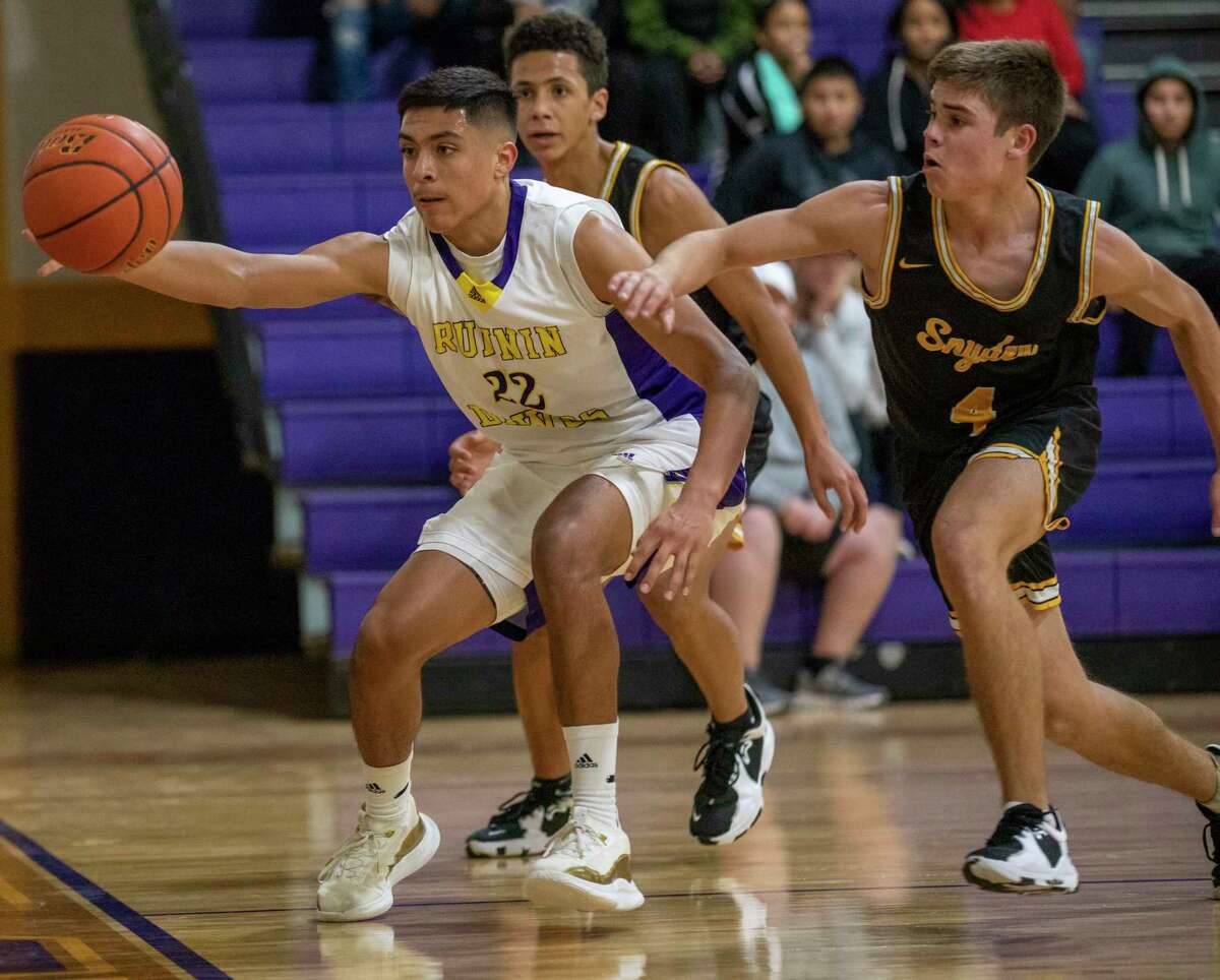 Midland High’s Jaime Puentes (22) saves the ball from going out of bounds as Snyder’s Hunter Stewart (4) attempts to grab the ball Tuesday, Dec. 7, 2021 at Midland High School. Jacy Lewis/Reporter-Telegram