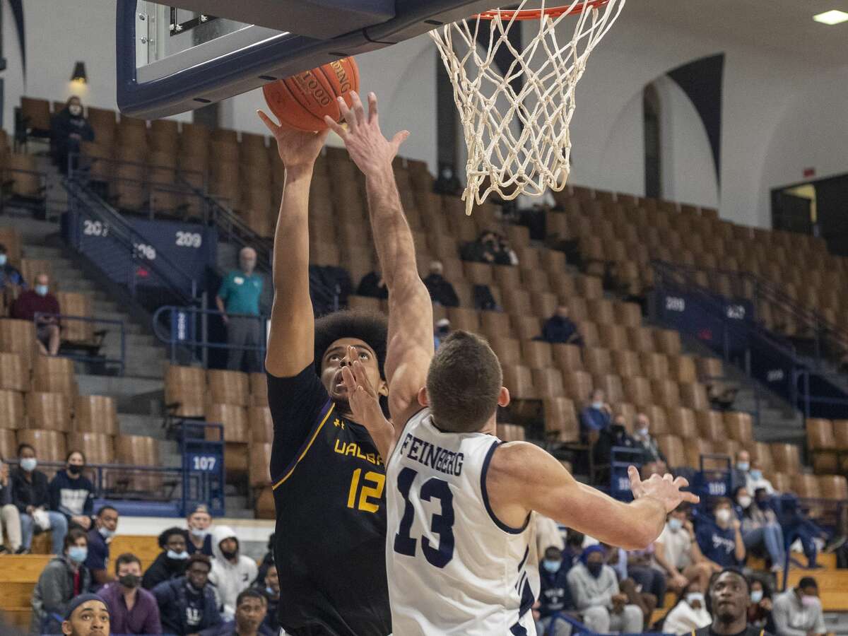 Justin Neely of UAlbany puts up a shot over Yale's Michael Feinberg on Tuesday, Dec. 7, 2021.