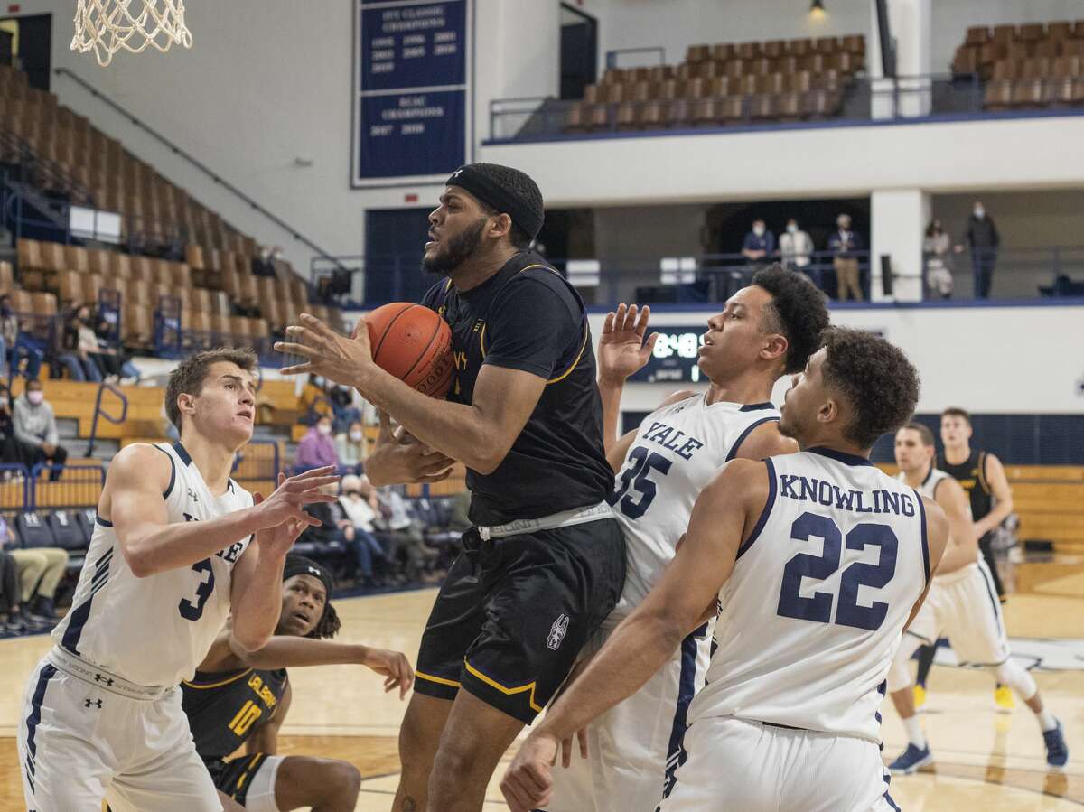 Jarvis Doles of UAlbany tries to control the ball among three Yale defenders, including former Albany Academy standout August Mahoney, left, during their game on Tuesday, Dec. 7, 2021.