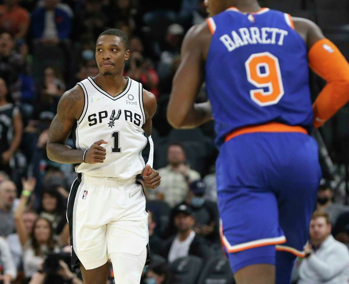Spurs’ Lonnie Walker, IV (1) backpedals after scoring a 3-pointer against the New York Knicks’ RJ Barrett (9) at the AT&T Center on Tuesday, Dec. 7, 2021.