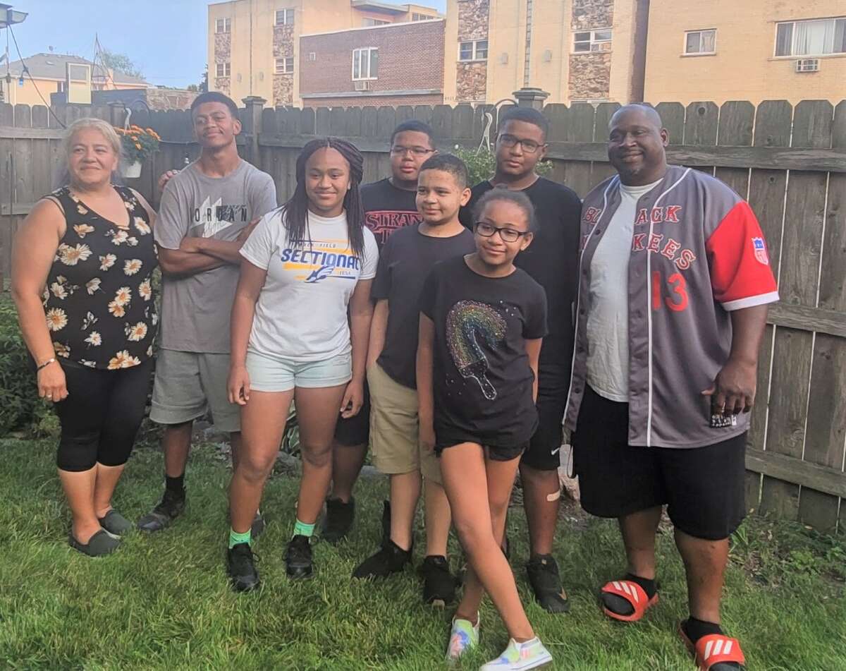 Members of the Phillips family are shown in a recent photo in their backyard in Alton. Lupe Phillips, far left, has created a GoFundMe page for the family after her husband, Durondo, far right, was injured in a tree felling accident a few days before Thanksgiving.