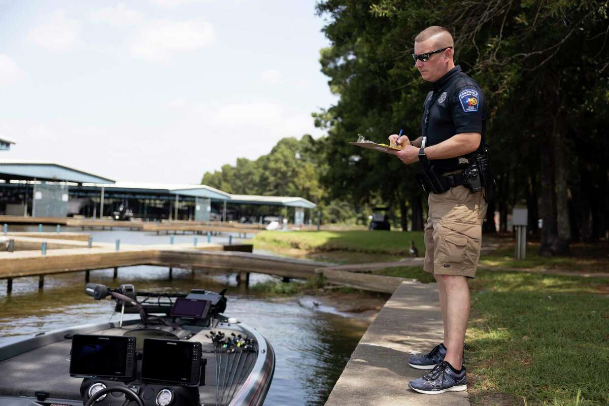 In this Sept. 4, 2021 file photo, Montgomery County Constable Precinct 1 Deputy Jarrett Rhodes conducts a safety check for a boater during Labor Day Weekend at Stowaway Marina & RV Park in Lake Conroe. The year saw an increase in fatalities on the popular lake compared to previous years.
