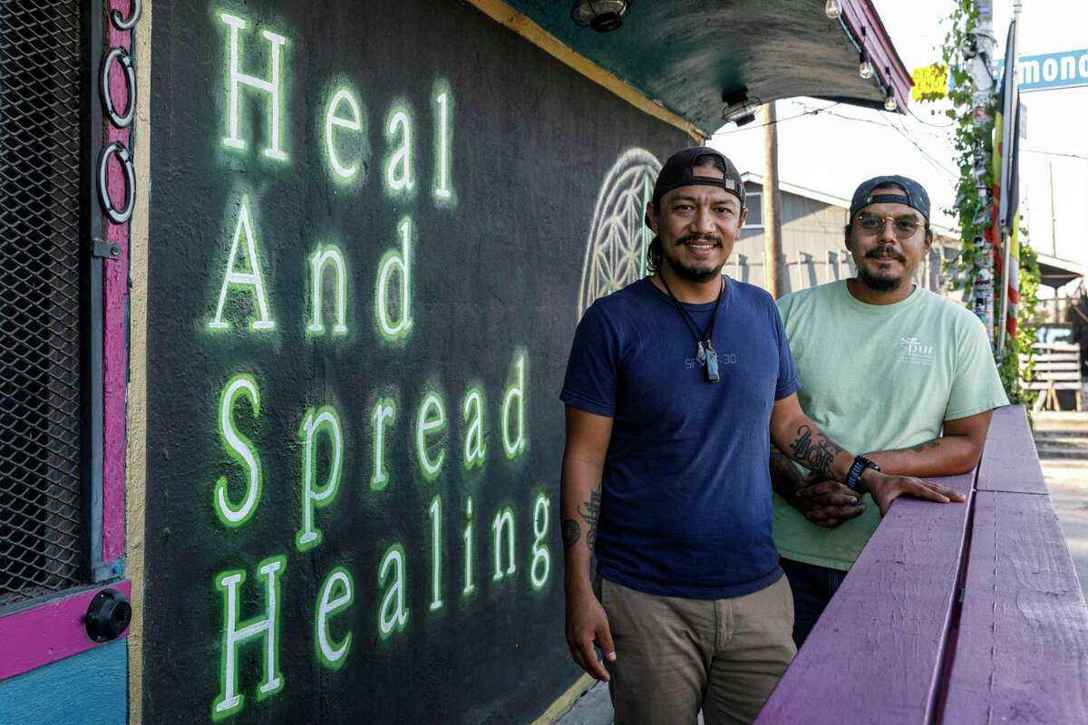 Rogelio, left, and Michael Sanchez stand outside of their restaurant HASH Vegan Eats on the South Side of San Antonio, Texas, Tuesday, Nov. 23, 2021. HASH stands for Heal And Spread Healing and the menu is filled with vegan food and non-alcoholic drinks.