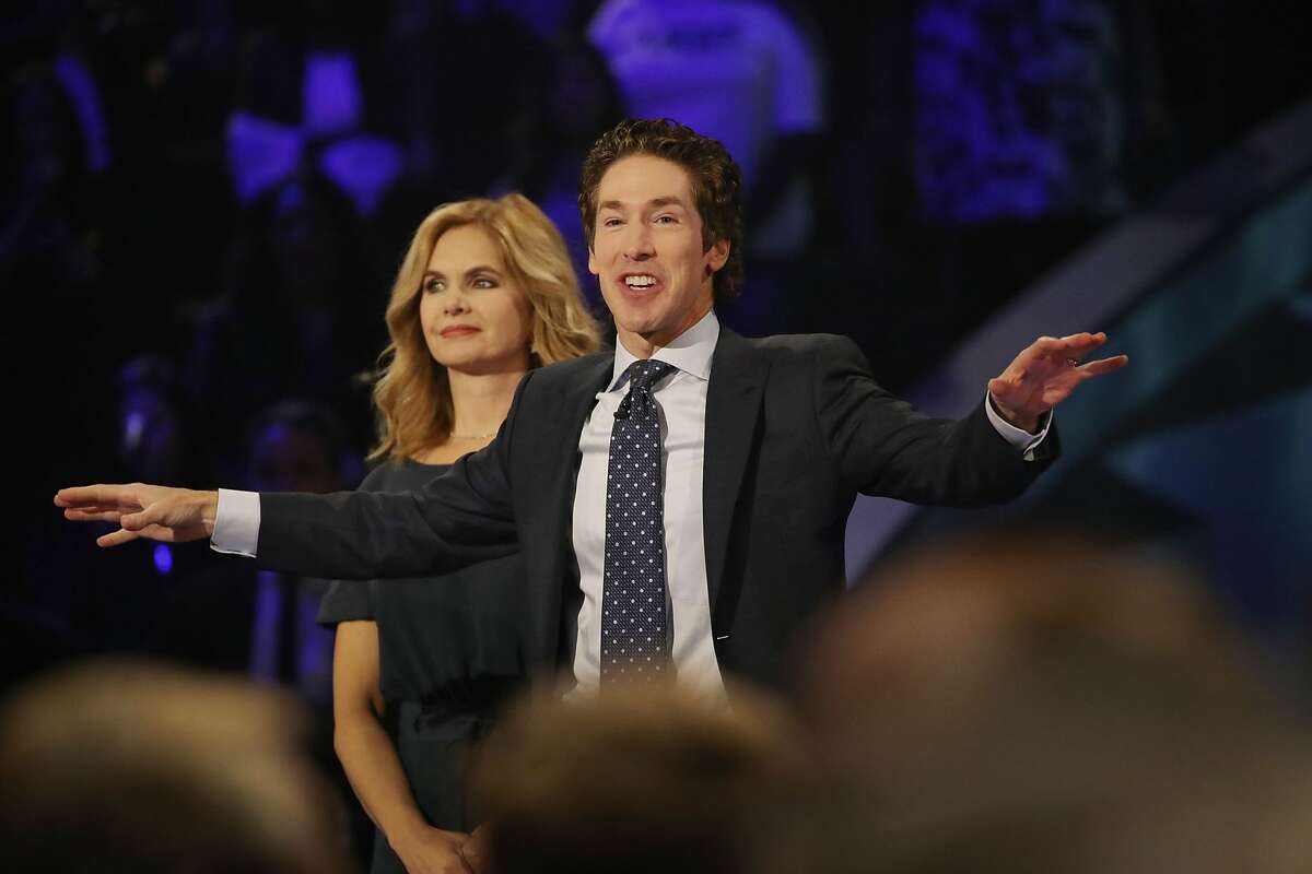 Joel Osteen, the pastor of Lakewood Church, stands with his wife, Victoria Osteen, as he conducts a service at the Houston church. 