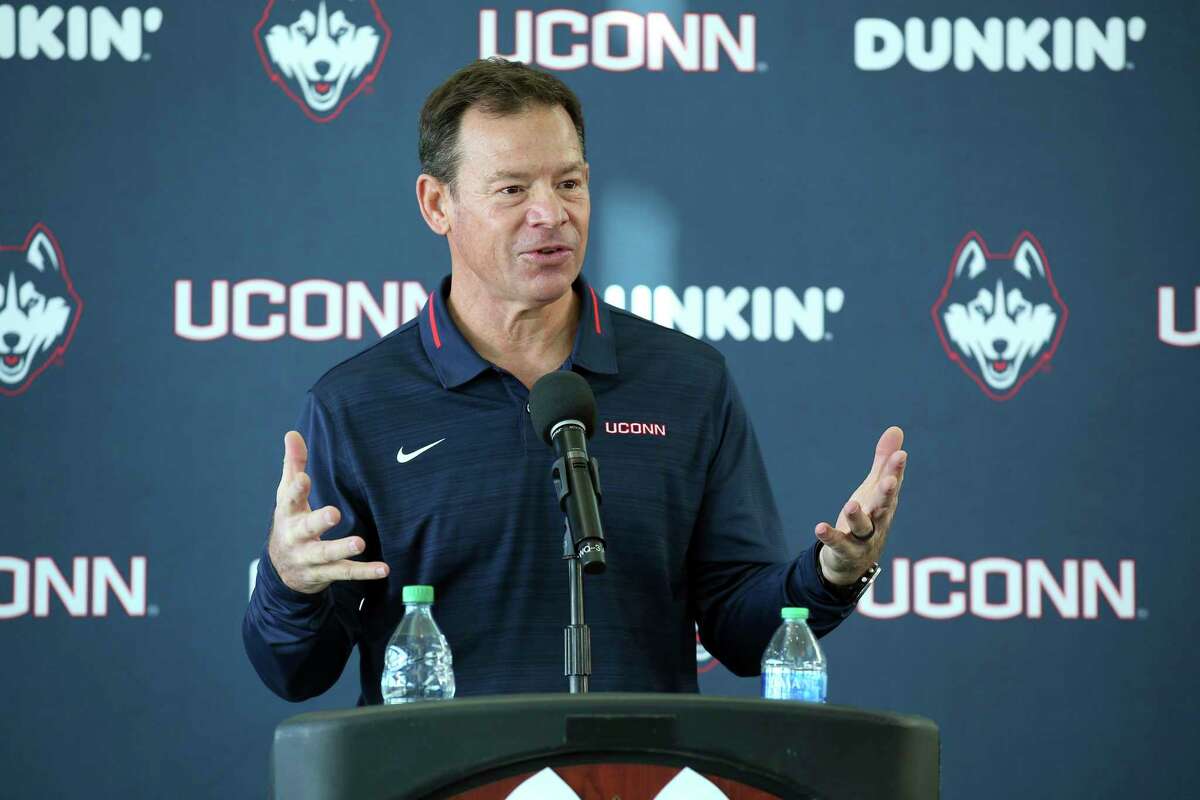 Jim Mora speaks with the media during a press conference announcing him as the new coach of UConn football on Nov. 27, 2021, in East Hartford, Conn. Mora has added Gordon Sammis as his offensive line coach after Sammis left the same role at William & Mary.