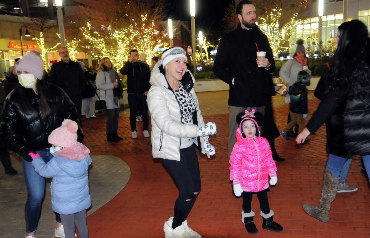 Sherri Pellinii, of Stamford, in center, and her granddaughter Paige McKniff, 2, dance to live music during the 11th annual Harbor Point Christmas Tree Lighting on Harbor Point Road in Stamford, Conn., on Tuesday December 7, 2021. Following the tree lighting, visitors enjoyed live music, hot chocolate as well as some of Harbor Point’s favorite dining options such as Bareburger, Patisserie Sulzburg, Fortina, Mexicue and Sign of the Whale.