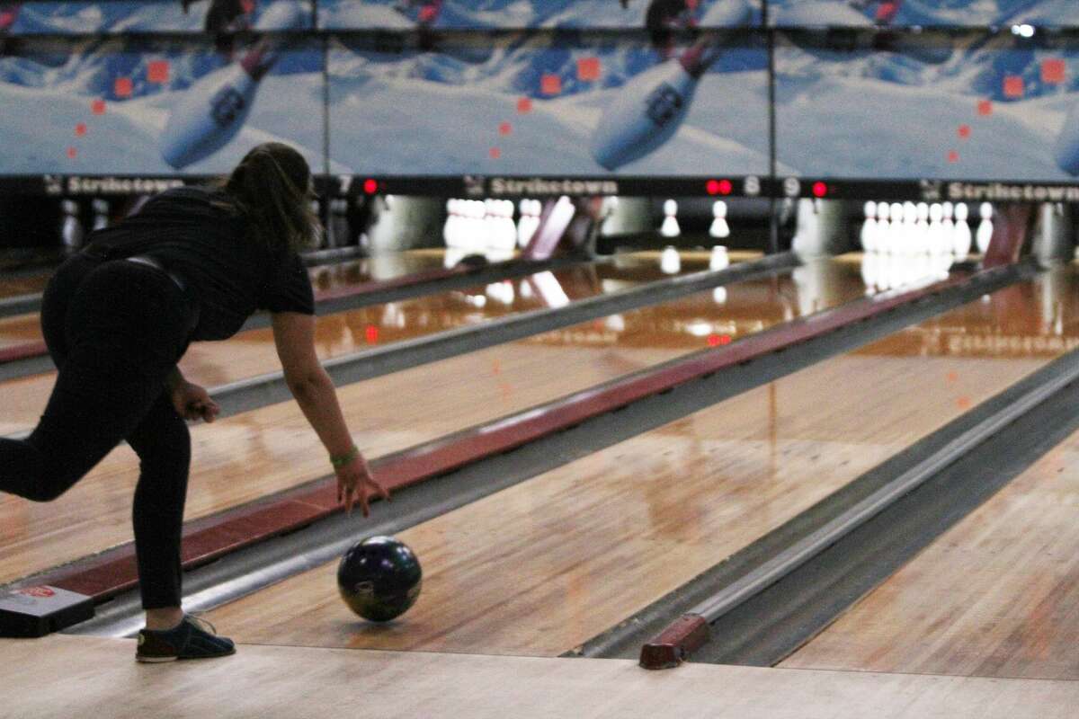 Manistee Catholic Central's Madison Antal goes for a strike at Striketown in Manistee.