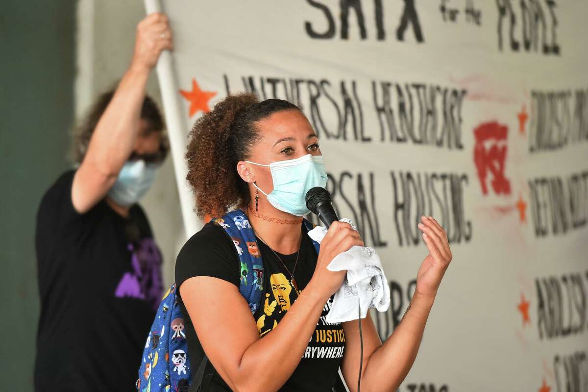 Ananda Tomas speaks to participants during a National Day of Protest against evictions, foreclosures, police brutality and racism Saturday in downtown San Antonio.