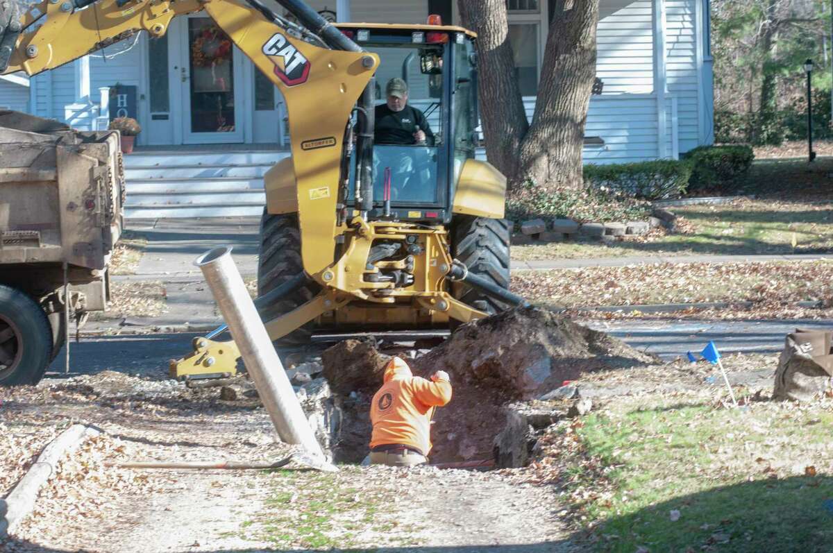 Municipal employees dig Wednesday near a driveway along Pine Street as they work to repair a collapsed sewer line. Pine Street from West State Street to West Douglas Avenue will be closed for the rest of the week while the repairs are made.