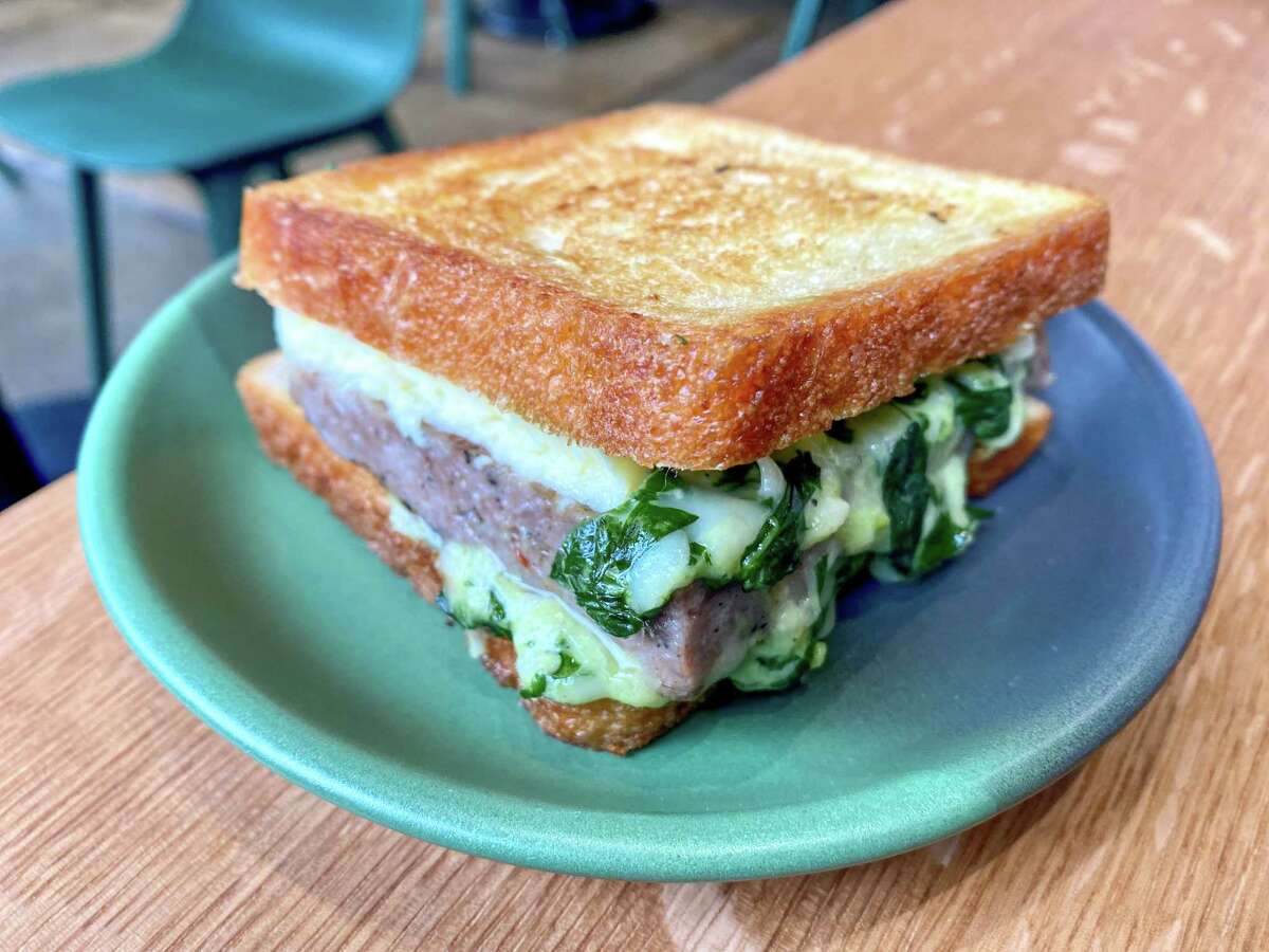 The Automat breakfast sandwich with chili herb cheese, breakfast sausage and an egg on fresh wondermat bread.