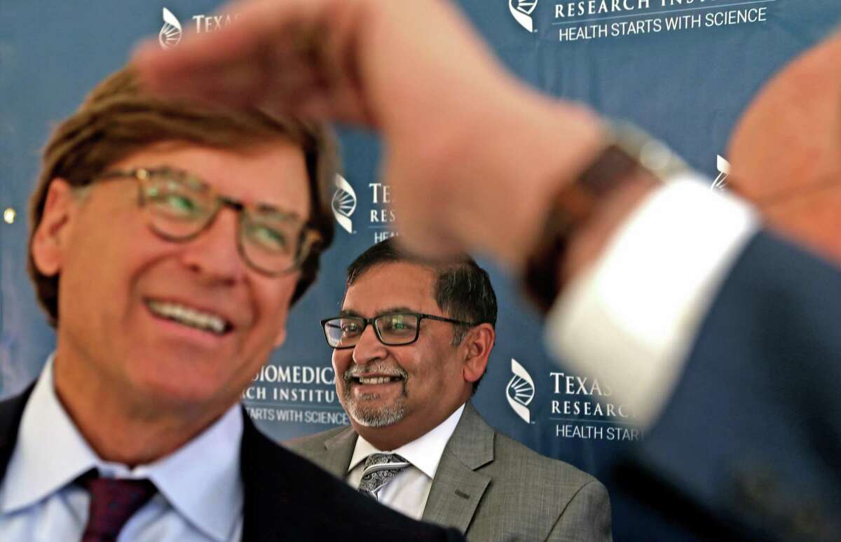 Dr. Deepak Kaushal, center, director of the Southwest National Primate Research Center, smiles during a groundbreaking ceremony for Texas Biomedical Research Institute’s new animal care complex. Dr. Andy Anderson, left, talks with Bexar County Judge Nelson Wolff. The animal care complex will provide new indoor and outdoor housing space and advanced veterinary care for up to 800 primates.