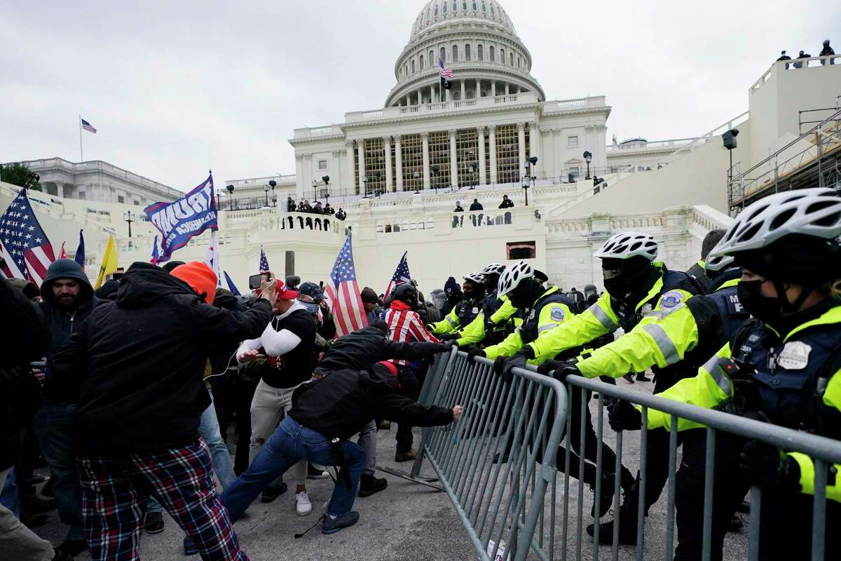 Violent insurrectionists loyal to President Donald Trump try to break through a police barrier at the Capitol in Washington on Jan. 6, 2021. Jenna Ryan, a Realtor from Frisco, who flaunted her participation in the riot on social media, recently made a TikTok in which she says jail will be good for her because she’ll be able to lose weight.