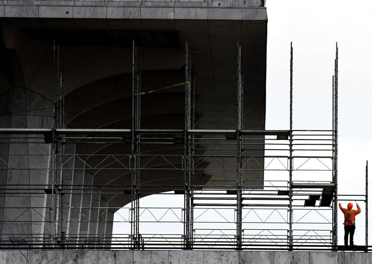 Scaffolding is assembled around the New York State Museum for inspection and remediation of its exterior marble panels on Wednesday, Dec. 9, 2021, at Empire State Plaza in Albany, N.Y. A panel fell from the ninth floor in Oct.