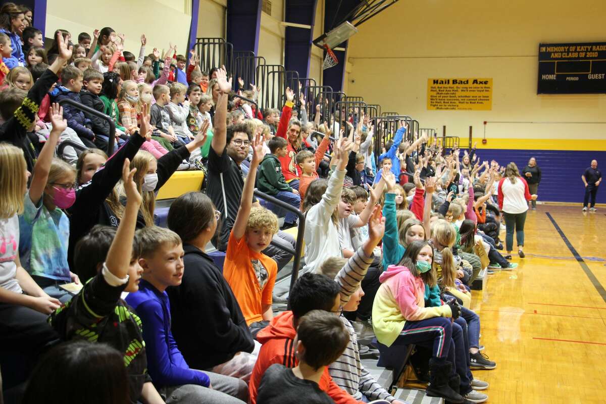 Kids raise their hands when asked how many have read Wright's books.