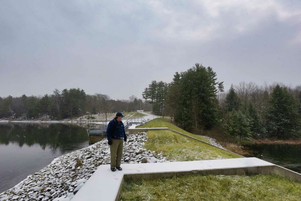 Sam Hall, Fort Ann town supervisor, stands up on the Hadlock Pond dam on Wednesday, Dec. 8, 2021, in Fort Ann, N.Y. The former dam at this site gave way back in 2005. After a Times Union investigation into the condition of dams in New York, lawmakers say more must be done to prevent future emergencies.