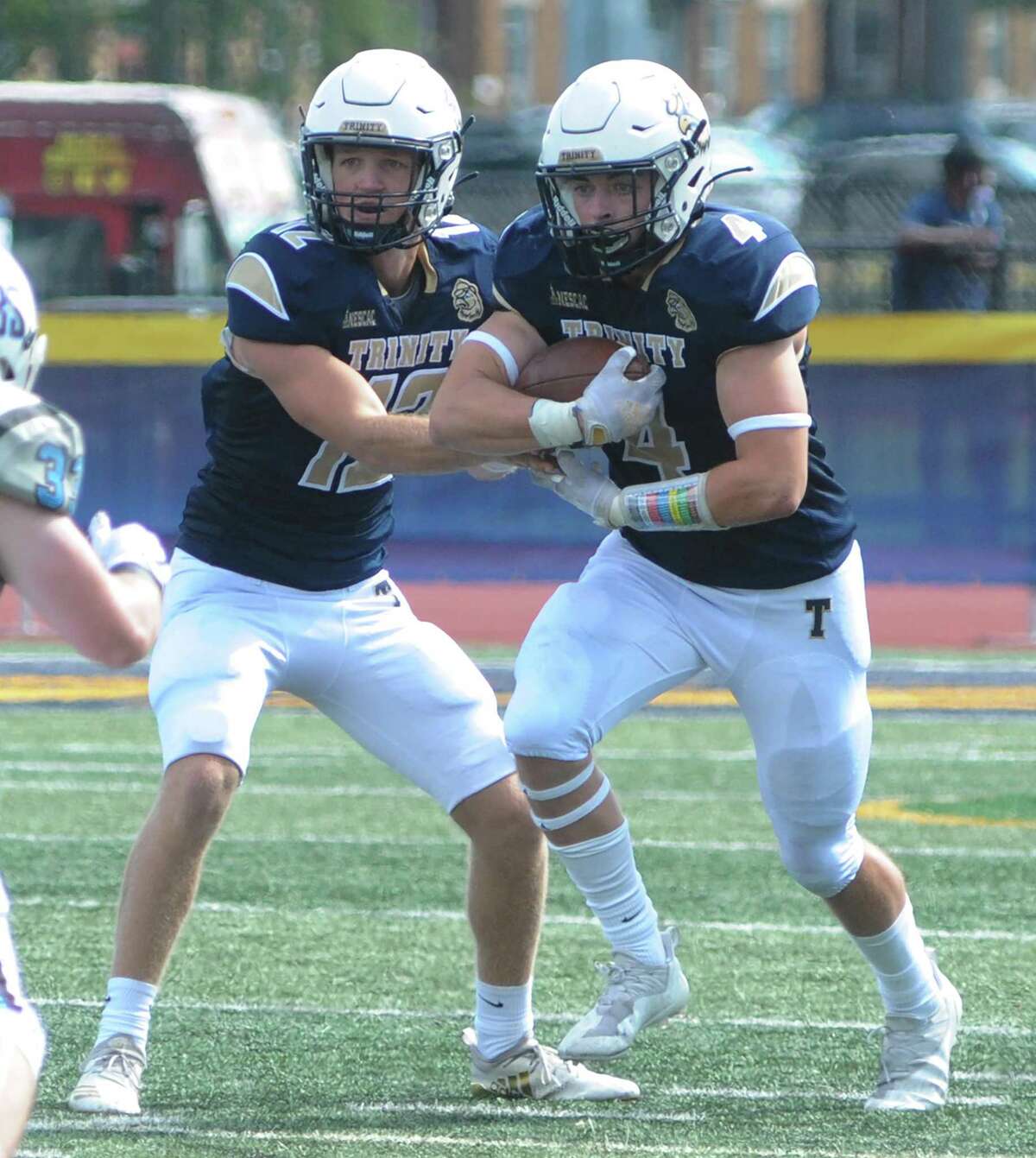 Darien's Will Kirby of the Trinity College football team takes a handoff from quarterback Spencer Fetter during a victory over Tufts in Hartford on Sept. 18. 2021.