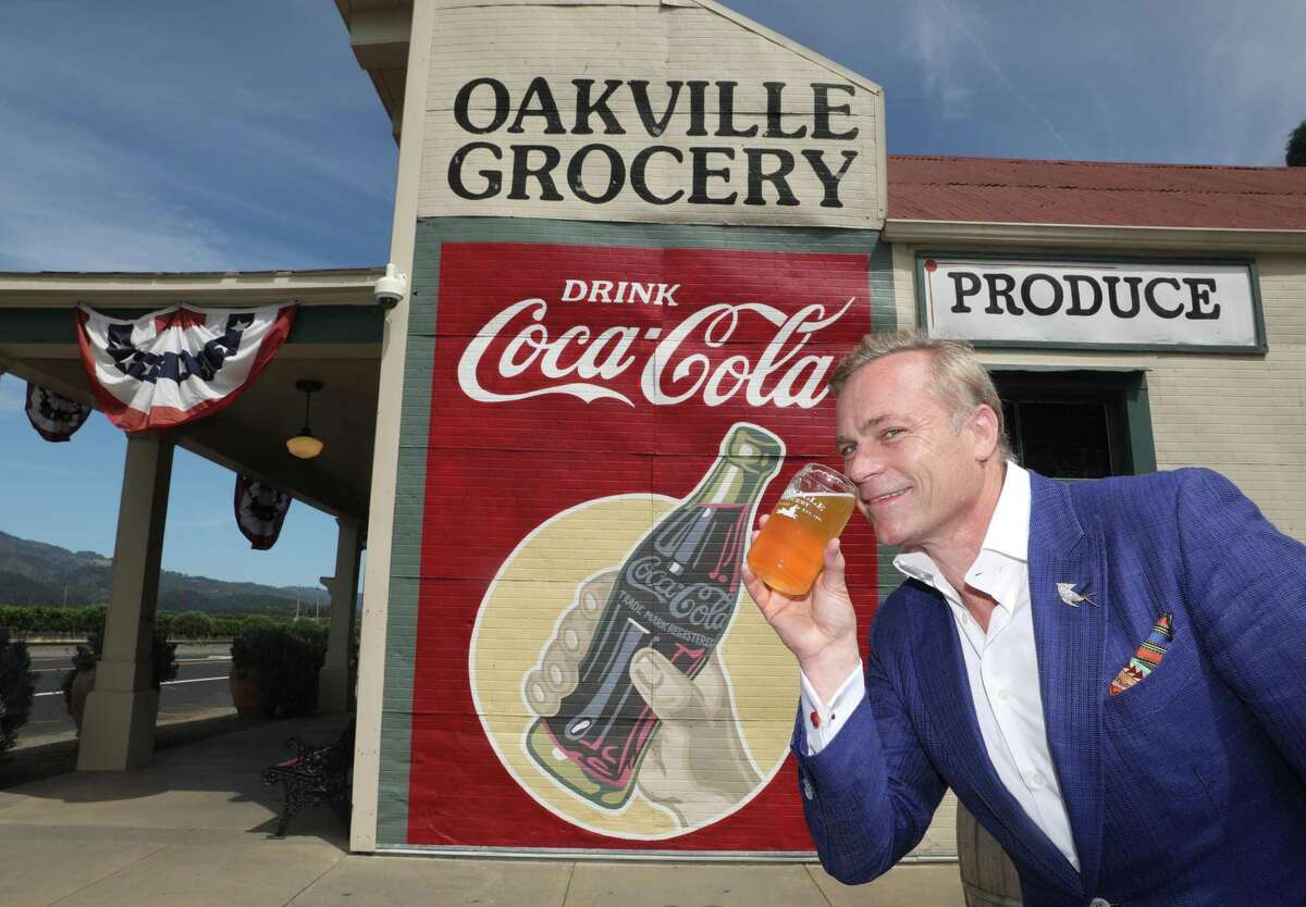 Vintner and entrepreneur Jean-Charles Boisset with a beer next to his historic Napa Valley landmark Oakville Grocery, which he bought in 2019.