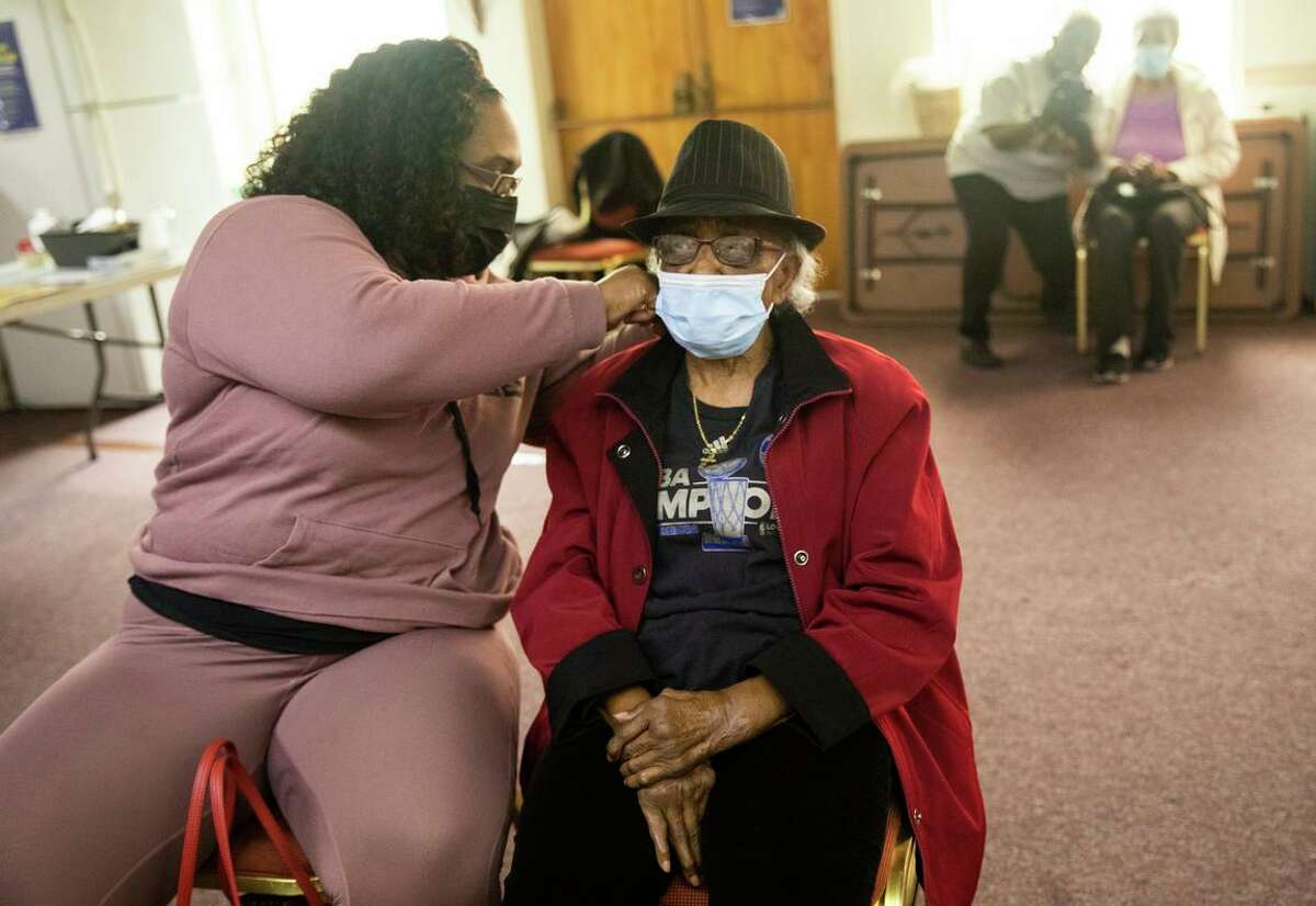 Virginia Harris, 93, waits with her granddaughter Ayisha Miles for fifteen minutes after receiving their COVID-19 vaccine booster shots at a pop-up vaccine booster clinic at New Providence Baptist Church in the Ingleside neighborhood of San Francisco.