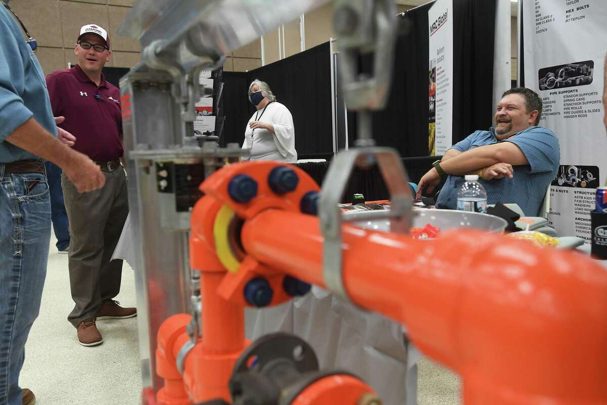 Trade workers socialize as they mingle during the industry trade show hosted by the Greater Port Arthur Chamber of Commerce at the Bob A. Bowers Civic Center Wednesday. Photo made Wednesday, August 4, 2021 Kim Brent/The Enterprise
