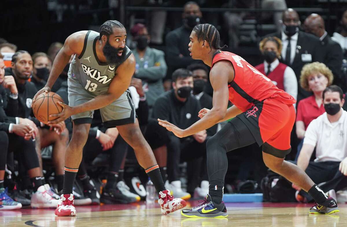 Brooklyn Nets guard James Harden (13) challenges Houston Rockets guard Josh Christopher (9) as he prepares to drive to the basket at the Toyota Center in Houston on Wednesday, Dec. 8, 2021.