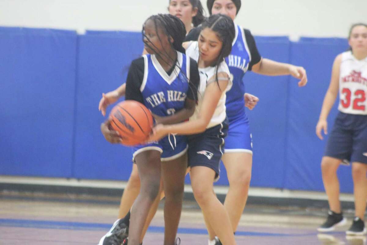 Realizing a Beverly Hills player isn't getting any help from her teammates, a Bondy player tries to force a jump ball Wednesday night.